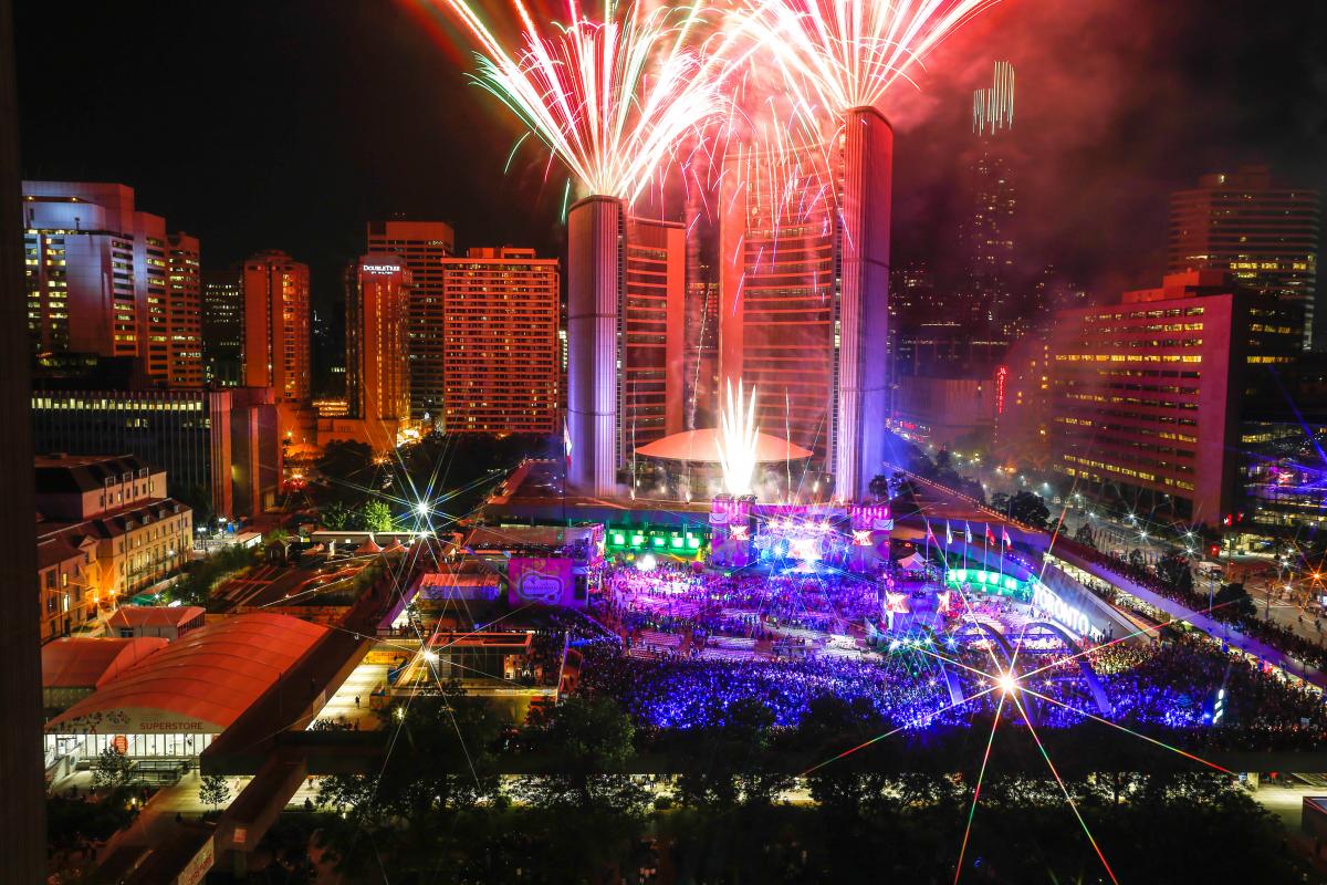 a high shot of fireworks and lasers in central Toronto