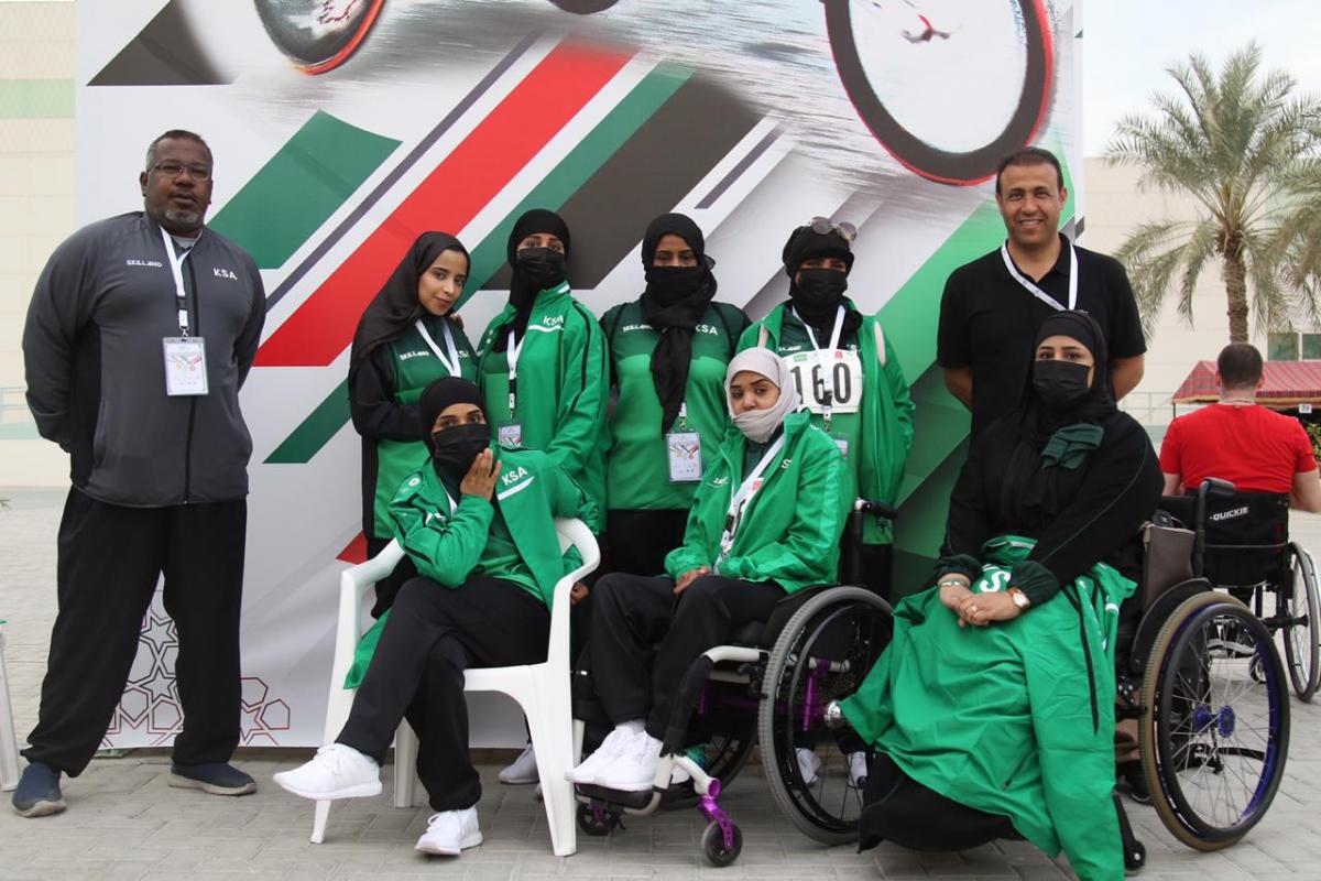 a group of female Saudi Arabian Para athletes and their two male coaches