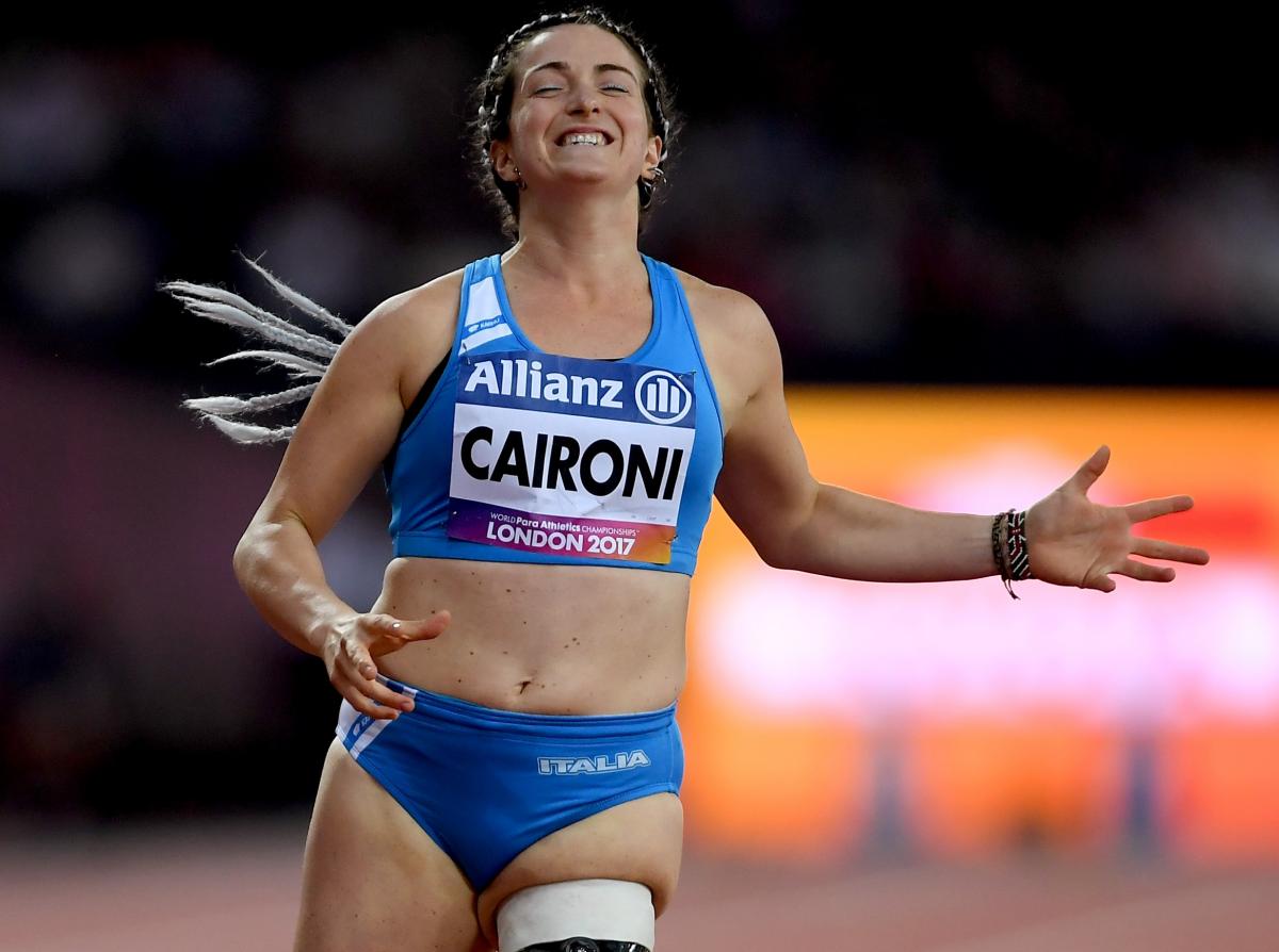 female Para sprinter Martina Caironi celebrates as she crosses the finish line