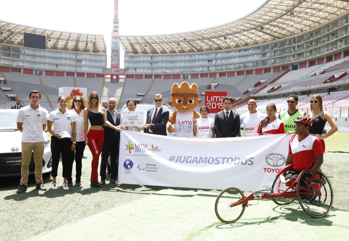 the Lima 2019 and a group of people standing in a stadium