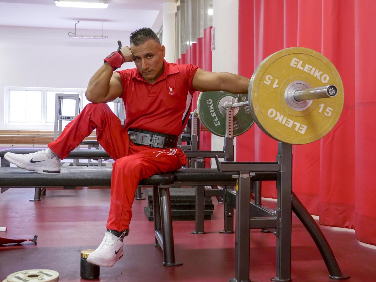 Peruvian powerlifter Niel Garcia Trelles poses on the benche staring at the camera