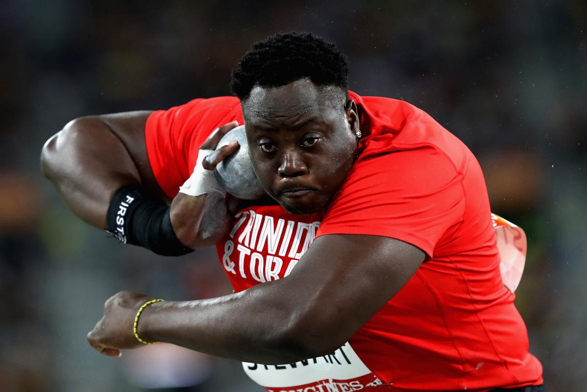 Akeem Stewart about to throw the shot while wearing a Trinidad & Tobago shirt