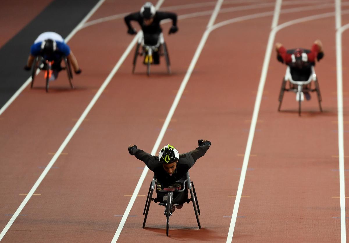 A wheelchair racer ahead of three competitors