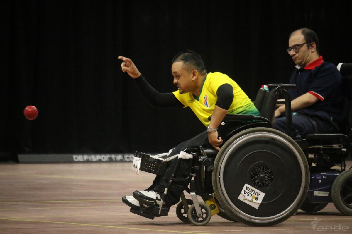 Brazilian boccia player in powerchair throws a ball